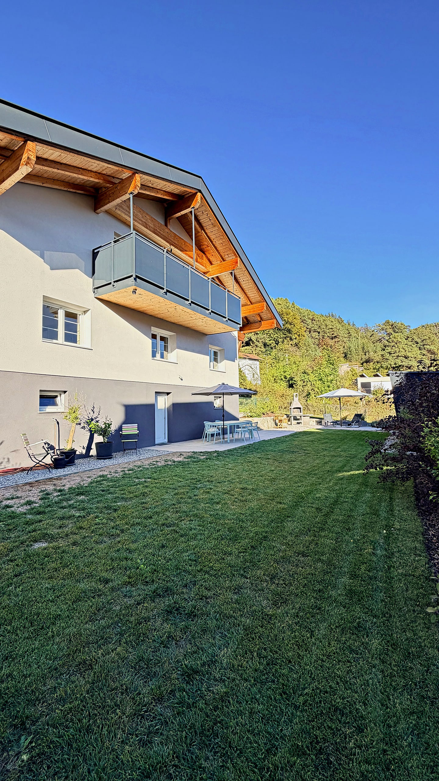 Freshly mown lawn along the house under a blue sky