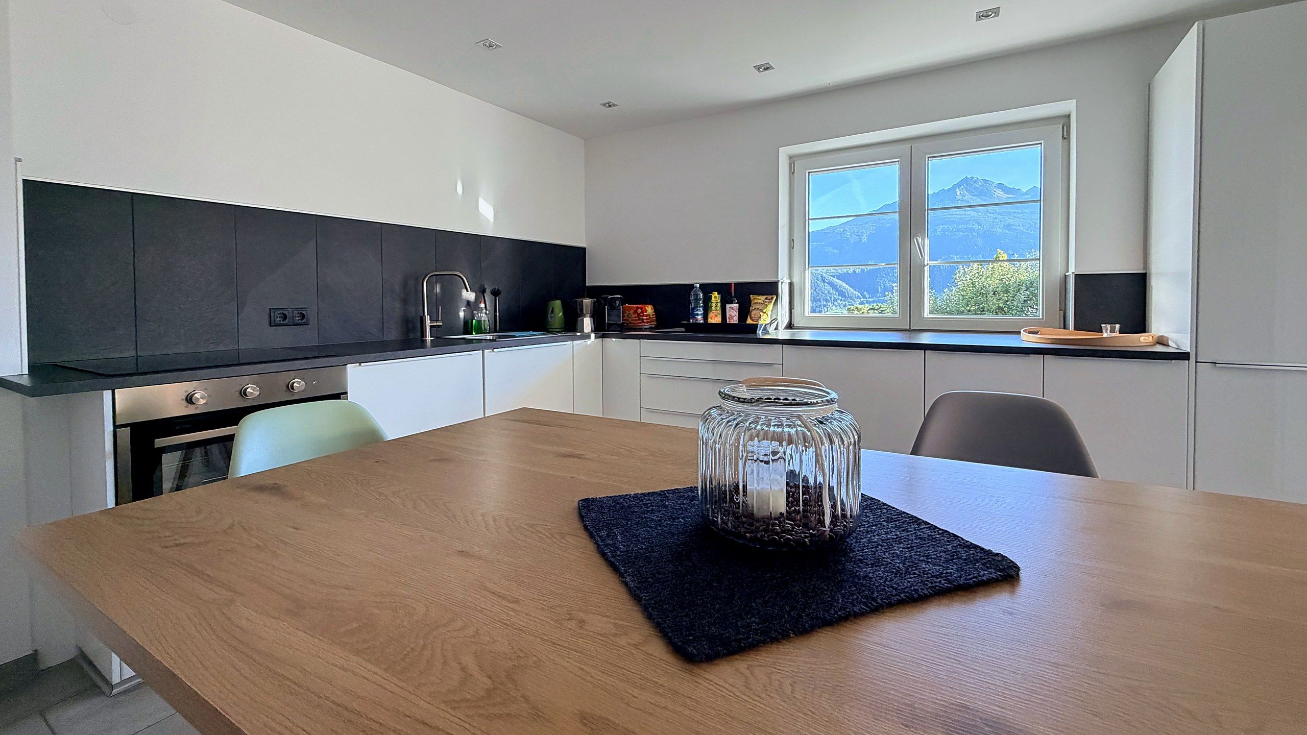 Dining table in the kitchen with a mountain view through the window