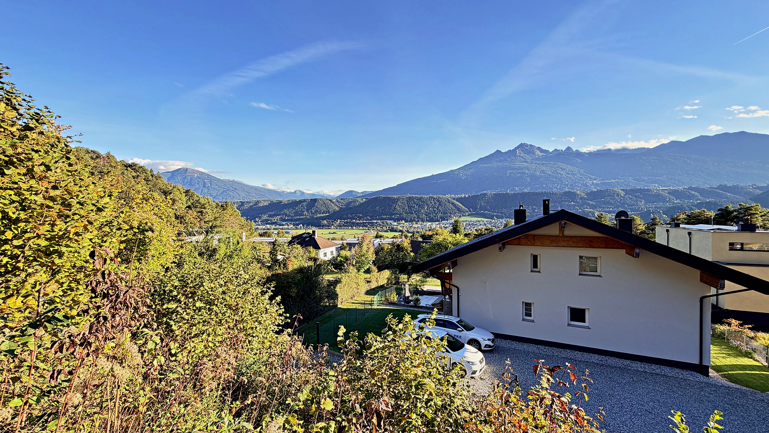 View from the slope over the house and the Inn valley to the mountain range